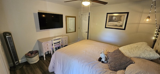 bedroom featuring a ceiling fan, baseboards, and dark wood-type flooring