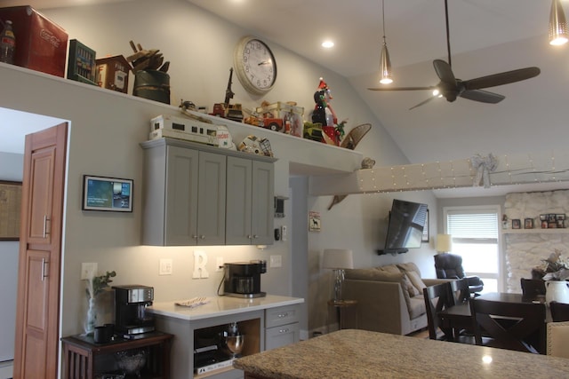 kitchen with high vaulted ceiling, a ceiling fan, open floor plan, and light countertops