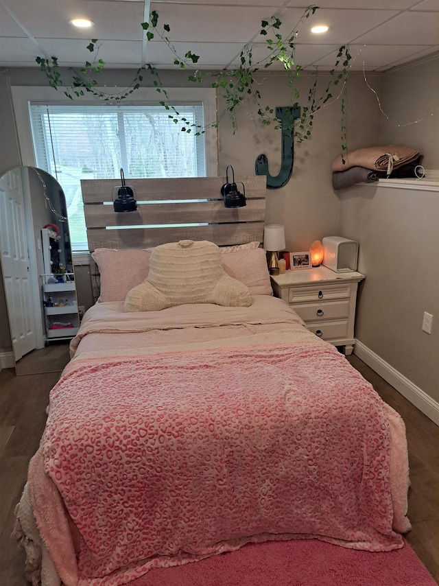 bedroom with dark wood-style floors and baseboards