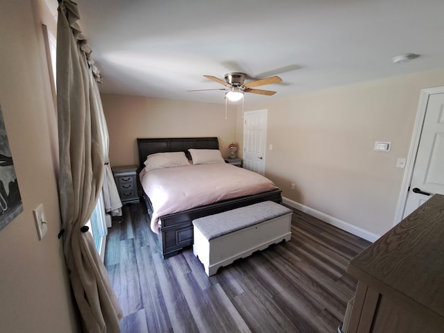 bedroom featuring ceiling fan, dark wood finished floors, and baseboards