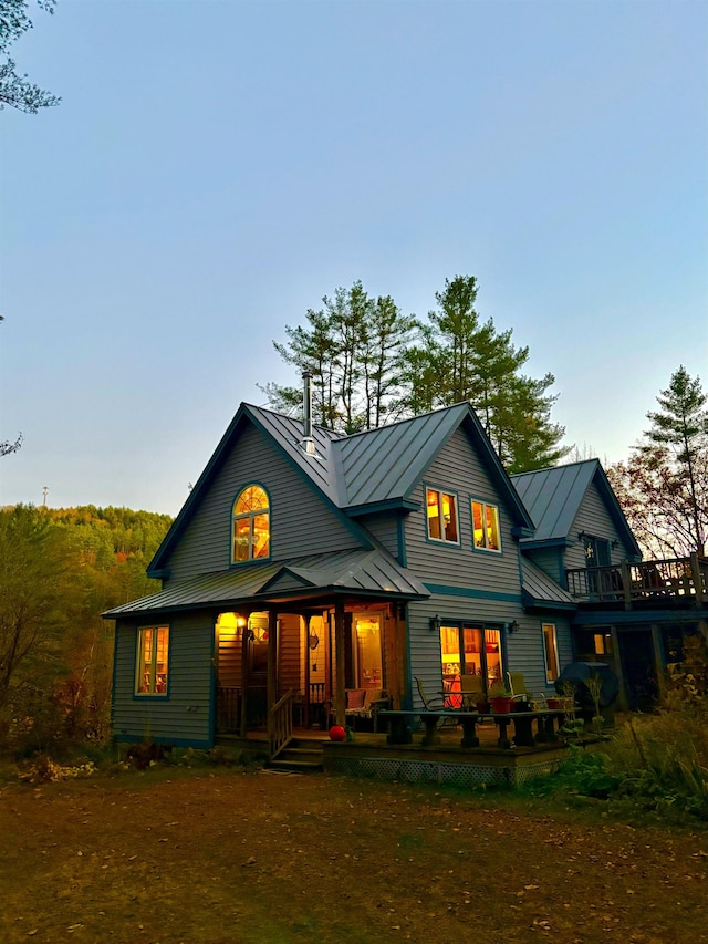 rear view of house with metal roof and a standing seam roof