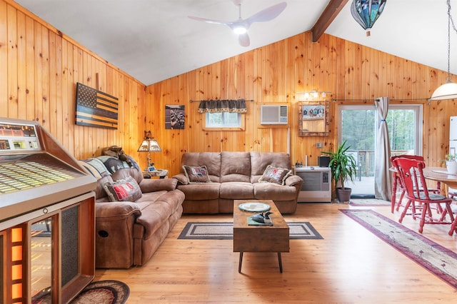living room with light wood-type flooring, lofted ceiling with beams, a ceiling fan, and wooden walls