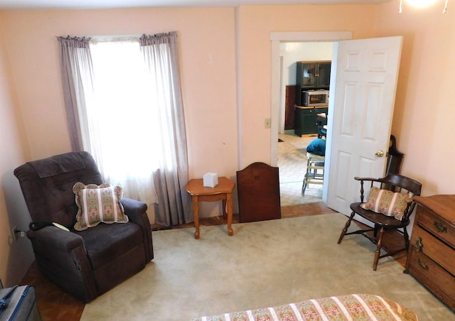 living area featuring light carpet