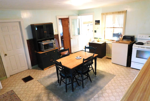 dining area with visible vents and light floors