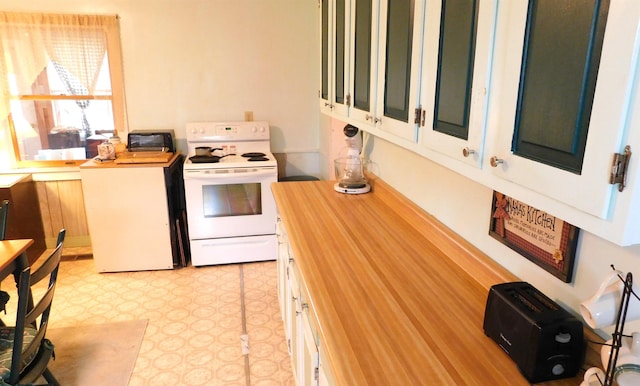 kitchen with wooden counters, light floors, and electric stove
