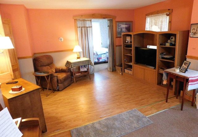 living room with plenty of natural light and wood finished floors