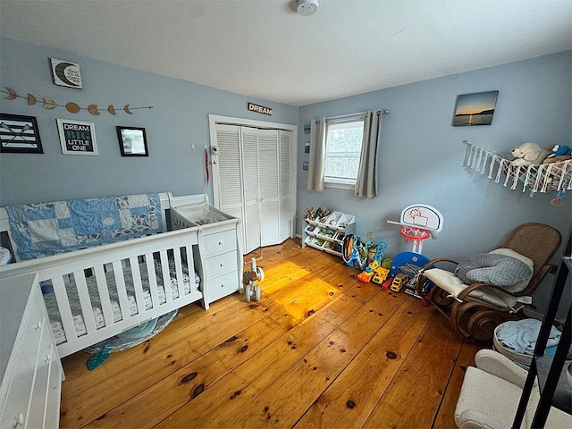 bedroom with a closet and hardwood / wood-style flooring