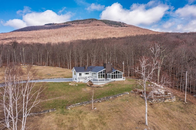 exterior space with a mountain view and a view of trees