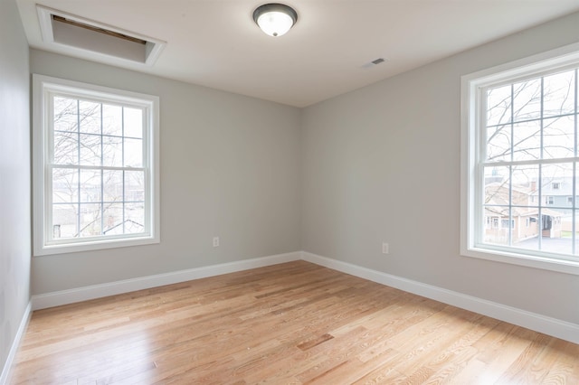43 Laton St Unit A, Nashua, NH 03064 - empty room with light wood finished floors, baseboards, visible vents, and a wealth of natural light