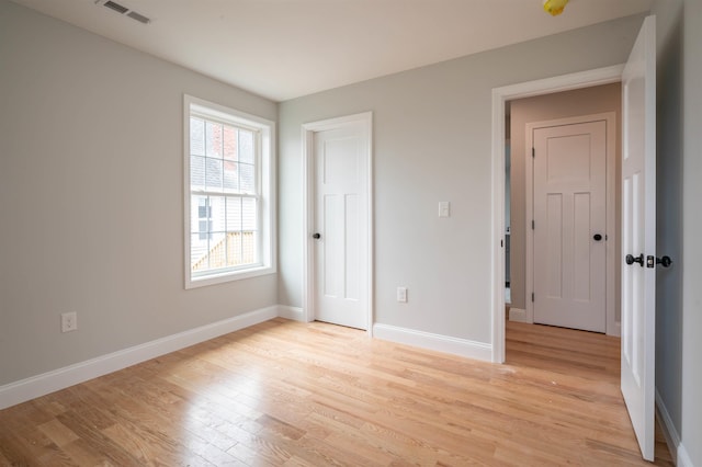 43 Laton St Unit A, Nashua, NH 03064 - unfurnished bedroom with visible vents, light wood-style flooring, and baseboards
