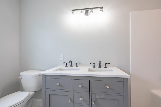 43 Laton St Unit A, Nashua, NH 03064 - bathroom with a sink, toilet, double vanity, and baseboards