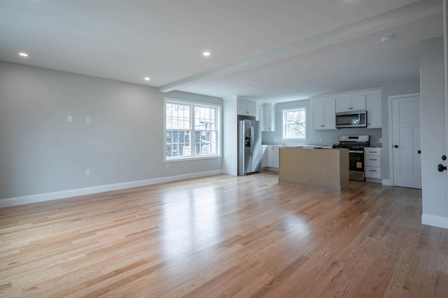 43 Laton St Unit A, Nashua, NH 03064 - unfurnished living room featuring recessed lighting, light wood-style flooring, and baseboards