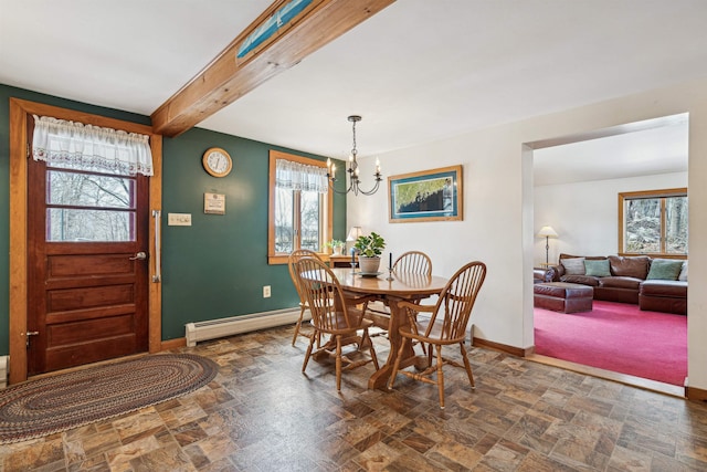 dining room with stone finish flooring, baseboard heating, baseboards, and a chandelier