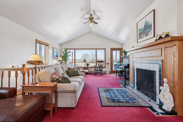 living area featuring a tile fireplace, ceiling fan, lofted ceiling, and carpet floors