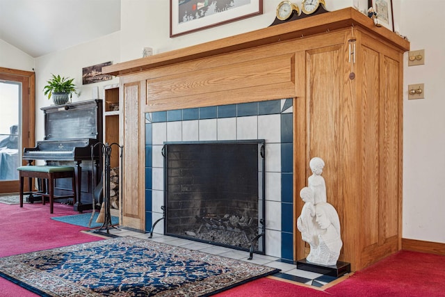 room details with carpet floors and a tile fireplace