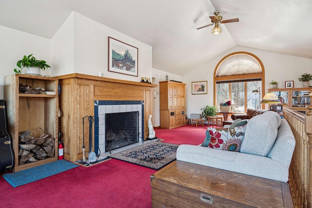 carpeted living area featuring a tiled fireplace, a ceiling fan, and lofted ceiling
