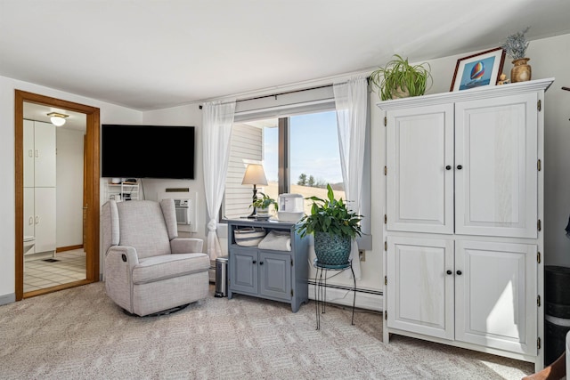 sitting room featuring light carpet and a baseboard heating unit