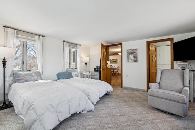 carpeted bedroom featuring baseboards