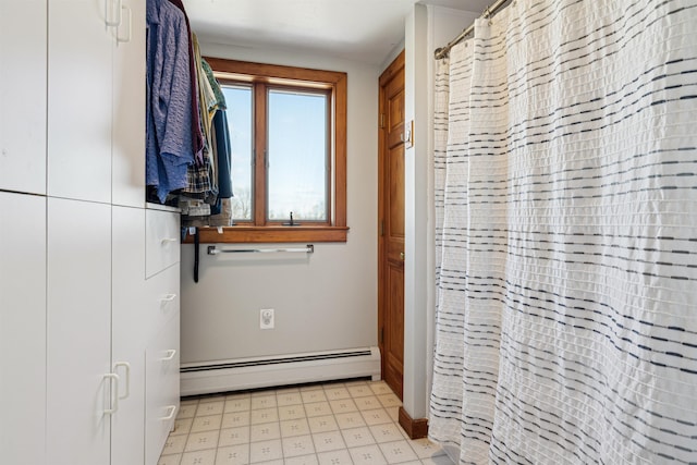 full bath featuring a shower with shower curtain, tile patterned floors, and baseboard heating