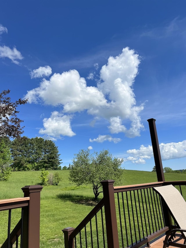 wooden terrace featuring a lawn