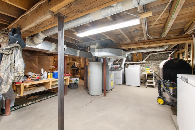 unfinished basement with water heater and washer and clothes dryer