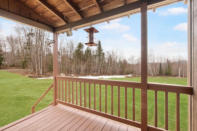 wooden terrace with a lawn