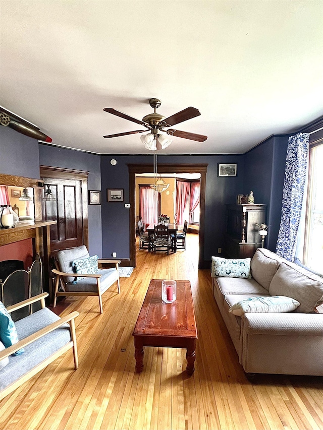 living area with ceiling fan and hardwood / wood-style floors
