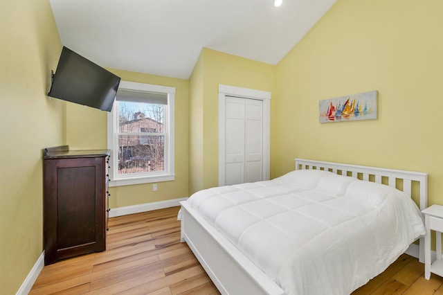 12 Wildwood Rd, Gilford, NH 03249 - bedroom featuring a closet, baseboards, vaulted ceiling, recessed lighting, and light wood-style floors