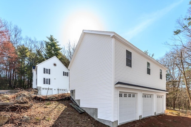 view of property exterior with an attached garage