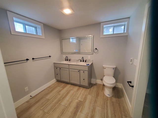 1761 US Route 2, East Montpelier, VT 05651 - bathroom with a sink, toilet, double vanity, and baseboards