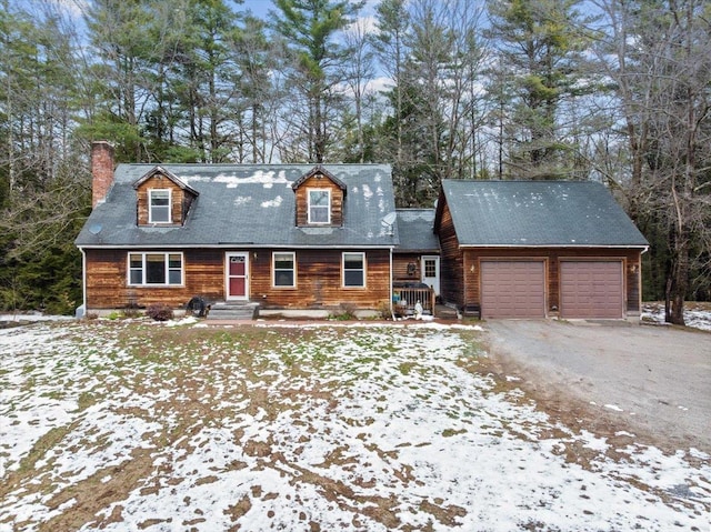 view of front of property featuring a chimney, a garage, and driveway