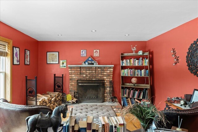 living area with recessed lighting and a fireplace