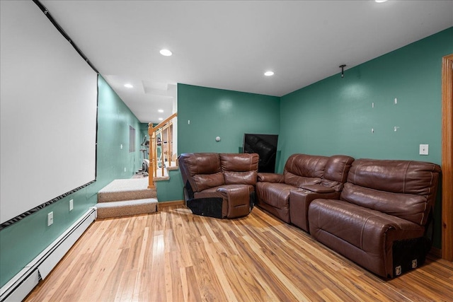 cinema with a baseboard radiator, wood finished floors, and recessed lighting