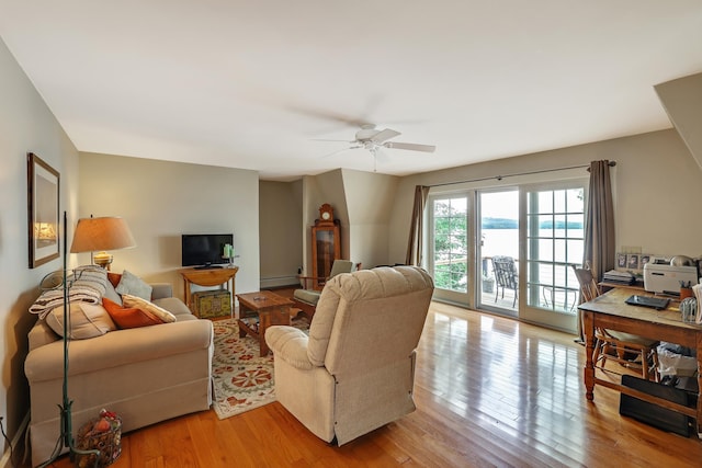 living area with ceiling fan, light wood-type flooring, and a baseboard radiator