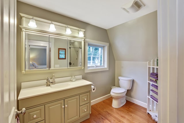 bathroom featuring baseboards, walk in shower, toilet, visible vents, and wood finished floors