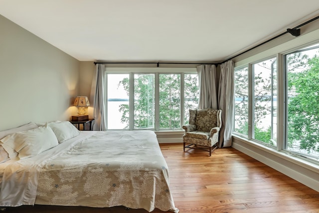 bedroom featuring light wood-style flooring and baseboards