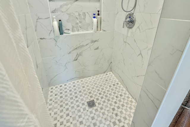 bathroom with tiled shower