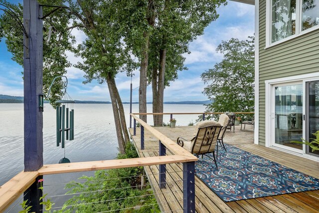 dock area featuring a deck with water view