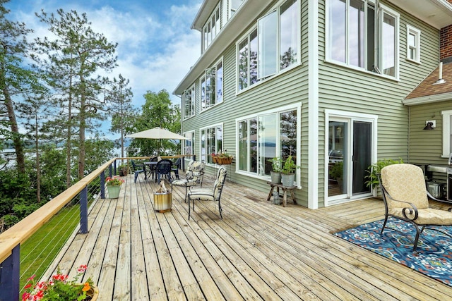 wooden terrace with outdoor dining space