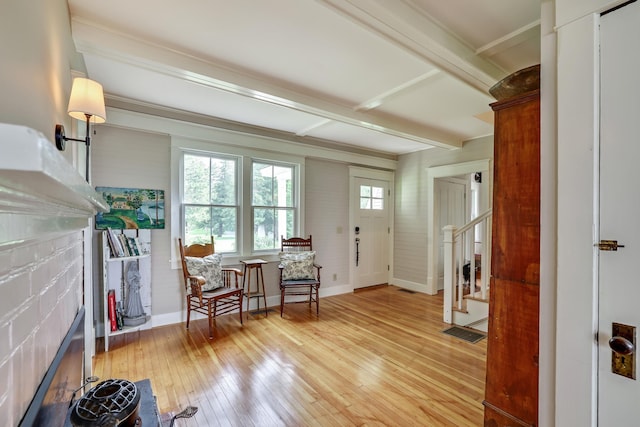 foyer featuring a fireplace, visible vents, stairway, light wood finished floors, and baseboards