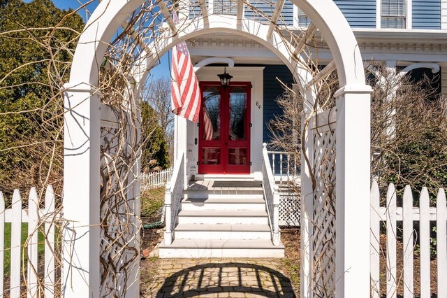 doorway to property featuring fence