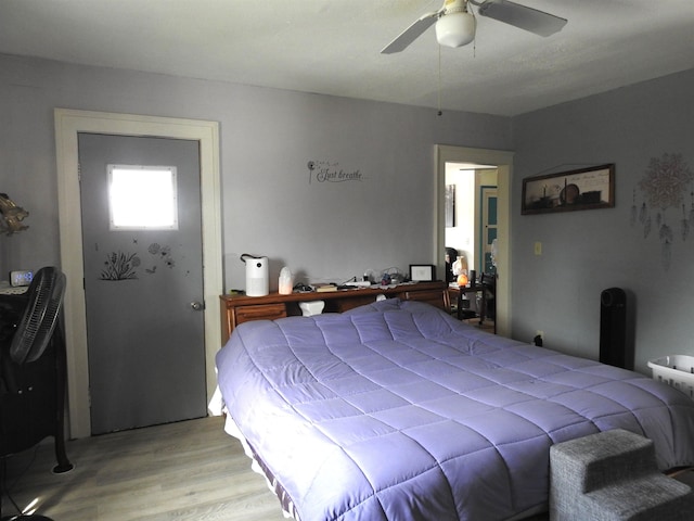 bedroom with light wood finished floors and ceiling fan