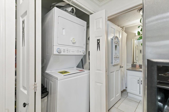 117A Chases Grove Rd, Derry, NH 03038 - laundry room featuring laundry area, stacked washer and clothes dryer, and light tile patterned floors