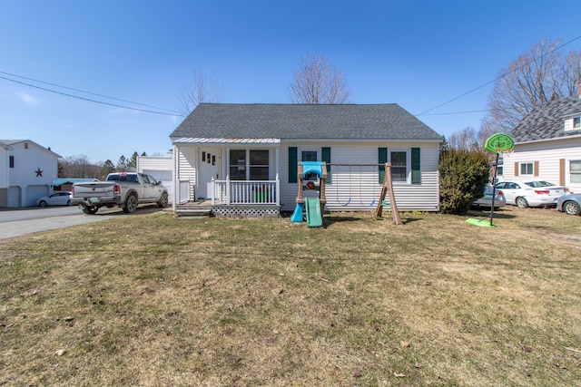 bungalow-style home featuring a porch, a shingled roof, and a front yard