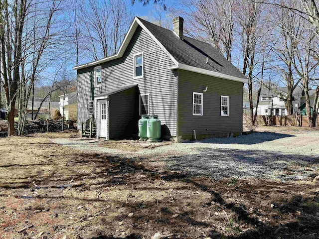 view of property exterior featuring a chimney