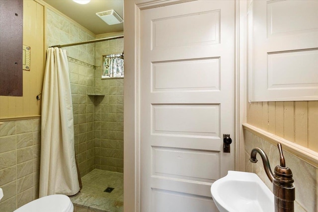 bathroom with a sink, visible vents, toilet, and a shower stall