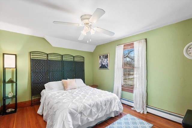 bedroom with baseboard heating, baseboards, ceiling fan, a baseboard radiator, and wood finished floors