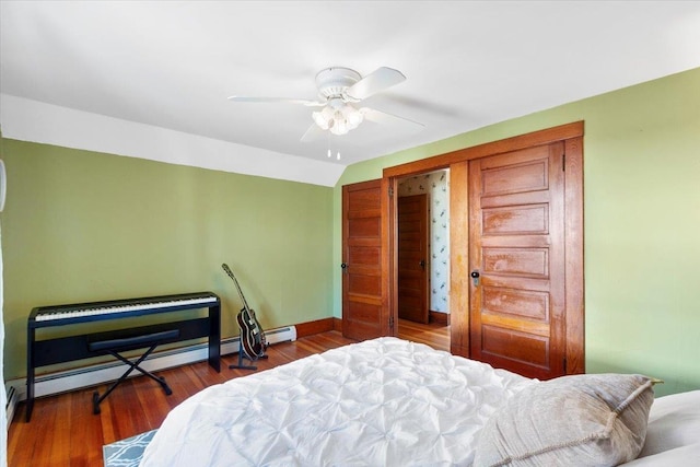 bedroom featuring a closet, vaulted ceiling, baseboards, a ceiling fan, and wood finished floors