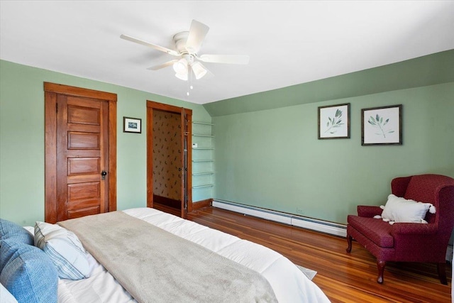 bedroom featuring ceiling fan, a baseboard heating unit, and wood finished floors