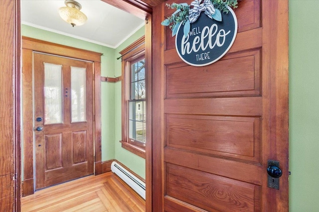 entryway with ornamental molding and a baseboard radiator